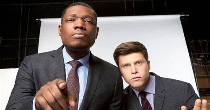 Colin Jost and Michael Che hosting the Weekend Update of SNL. Jost has a net worth of $6 million.